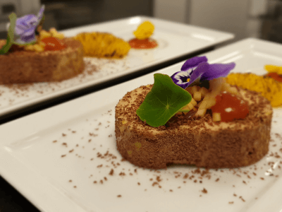 Foie gras covered in chocolate, burnt oranges, apples, bloody orange gel